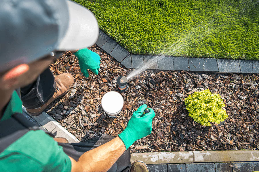 a man repairs a sprinkler systems