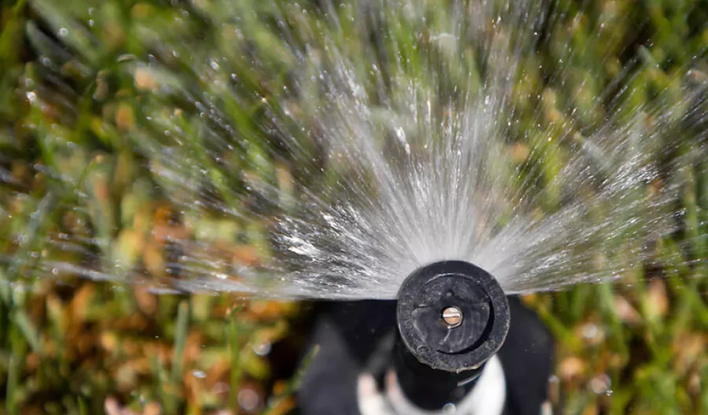 open lawn sprinkler at home